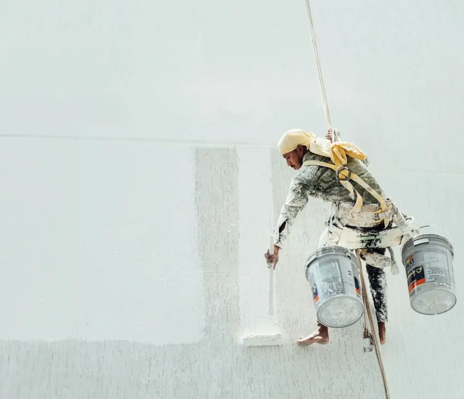 Painter painting a white façade